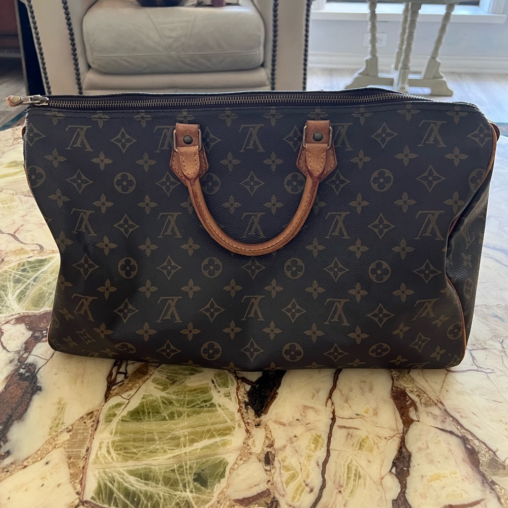 Vintage Vuitton duffle 30. Brown monogram with leather trim. Very good condition